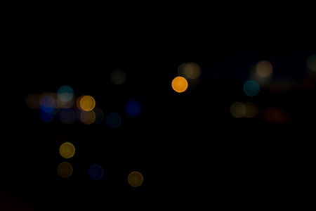 image of blurred bokeh background with colorful lights and Dark backgroundの写真素材
