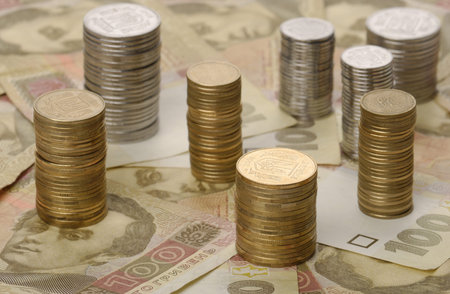stacks of coins on background of banknotes