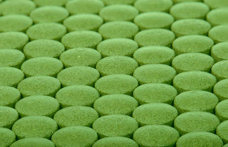 closeup background of green pillsの写真素材
