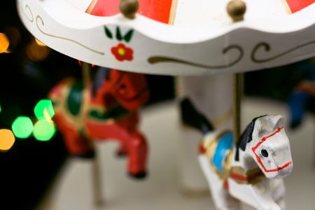 Miniature carousel with horses, against the background of New Year's lights. Depth of field for strong emotions.の写真素材