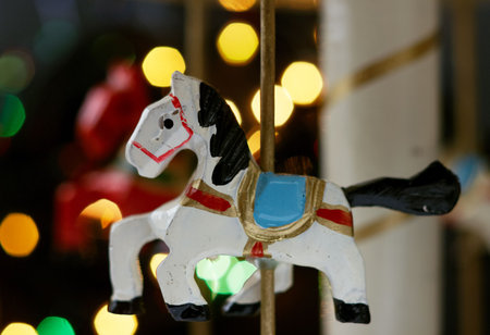 Miniature carousel with horses, against the background of New Year's lights. Depth of field for strong emotions.の写真素材