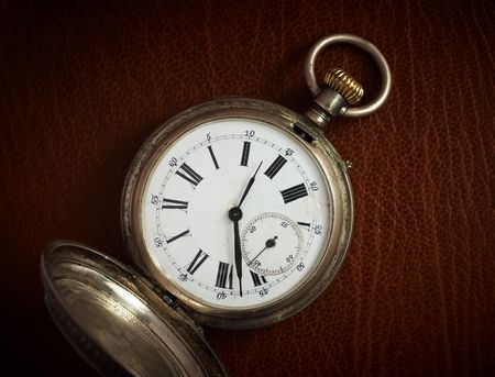 Old pocket watch on the natural leather backgroundの写真素材