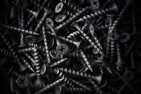 Dark gray screws solid backgroundの写真素材