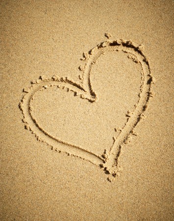 Heart drawn on sand.の写真素材