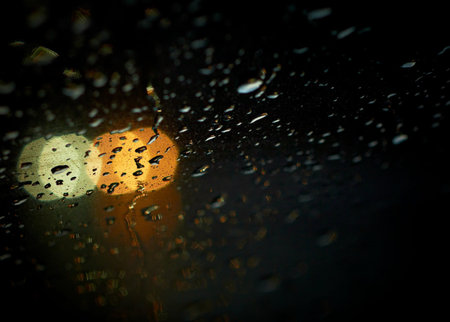 Rain drops with bokeh effect in the night city.