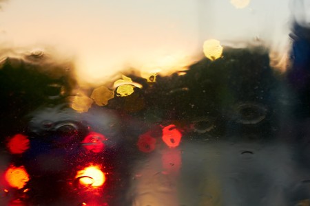 Rain drops with bokeh effect in provincial town at sunset.の写真素材
