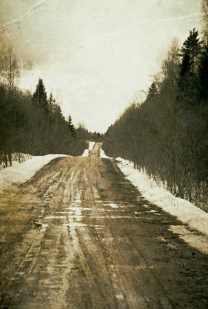 Vintage depressed and deserted village road. Grunge background.の写真素材