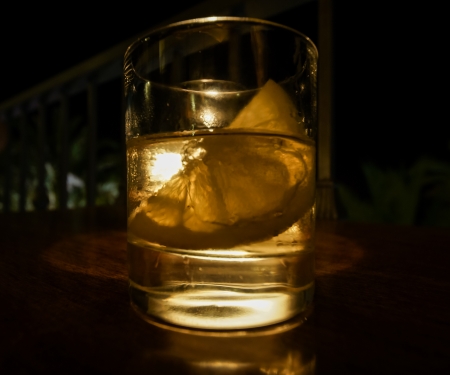 Coctail in glass with ice and lemon on blackの写真素材