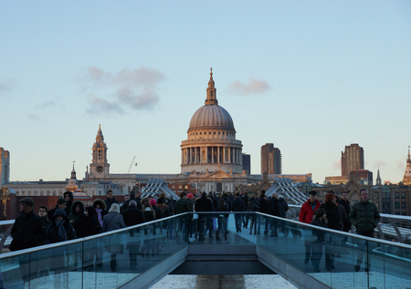 Millennium bridge at dusk. St Pauls cathedral in the background in Londonの写真素材