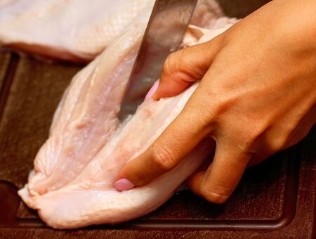 cutting chickenの写真素材