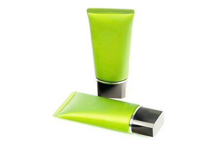 Green tubes with cream isolated on whiteの写真素材
