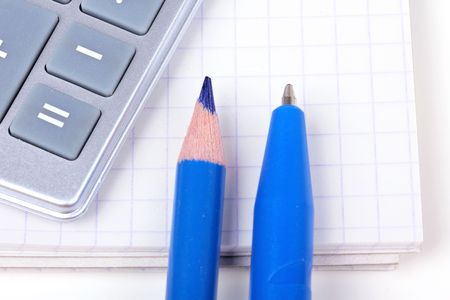 Calculator, pencil and pen on paper note, closed-up  on whiteの写真素材