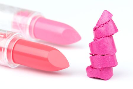 Two whole  and one sliced  lipsticks on white, closed-up の写真素材