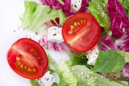 Salad with leafs,tomato and sheep cheese, closed-upの写真素材