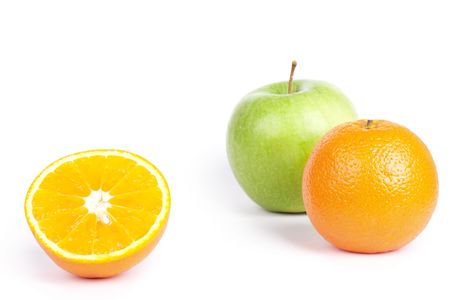 Oranges and green apple on white, closed-upの写真素材