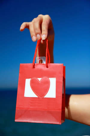 Present with heart in handの写真素材
