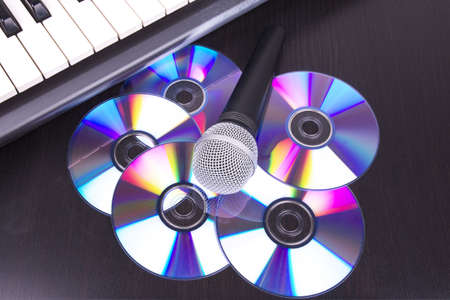 Vocal microphone,discs and electronic keyboard, closed-up on black table の写真素材
