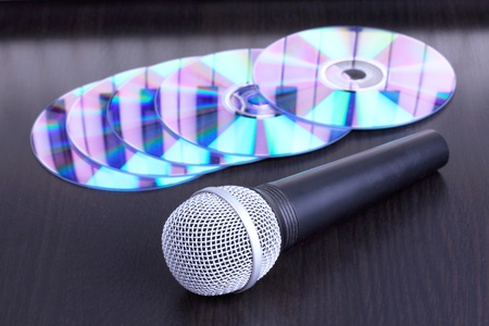 Microphone and cd disks on black table,closed-upの写真素材