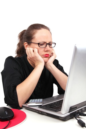 Sad businesswoman holding her head, sitting in officeの写真素材