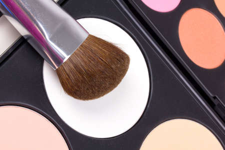 Professional make-up brushes on eyeshadows palettes, closed-upの写真素材