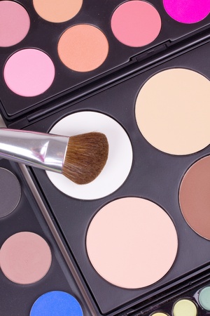 Make-up brushes on eyeshadows palettes, closed-upの写真素材