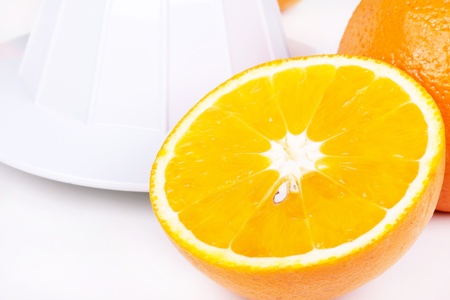 Juicer and oranges, closeup on white table の写真素材