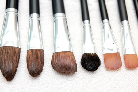 Wet make-up brushes on towel, close upの写真素材