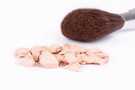 Crushed eyeshadows and make-up brush, closeup on white の写真素材