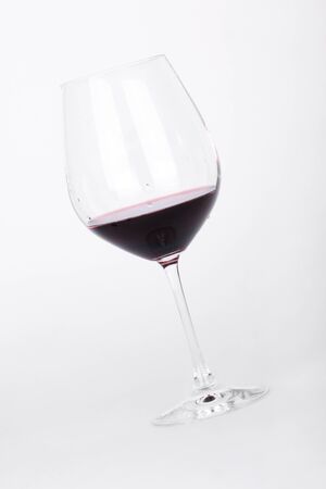 Wine in glass, closeup on whiteの写真素材