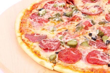 Pizza on wooden board, closeup on whiteの写真素材