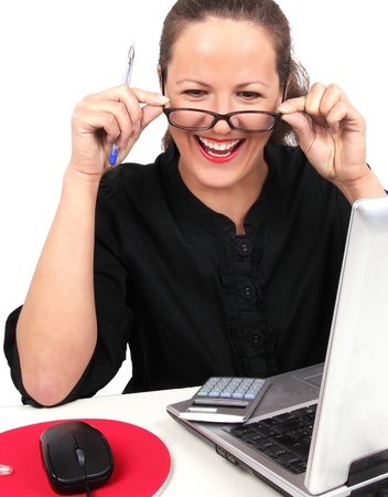 Smilling businesswoman with glasses in hands, sitting in officeの写真素材