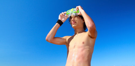 Man with swimming mask on sky background の写真素材