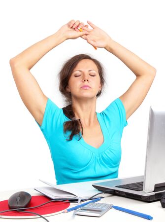 Tired woman sitting in office stretchingの写真素材