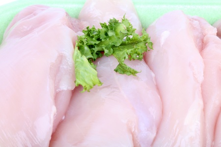 Raw uncooked chicken breast fillet in package, macro shotの写真素材