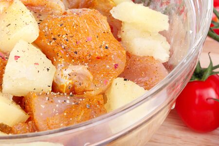 Cutted chicken breast fillet with pineapple pieces in bowl, closeupの写真素材
