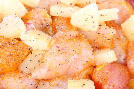 Cutted chicken breast fillet with pineapple pieces, closeupの写真素材
