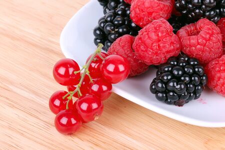 Different berries on white plate, closeupの写真素材
