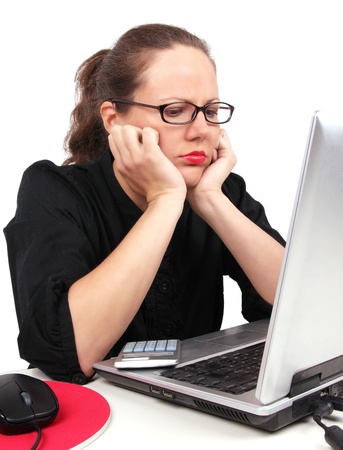 Sad businesswoman holding her head, sitting in officeの写真素材