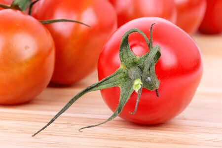 Tomato cherry on wooden board, closeup の写真素材