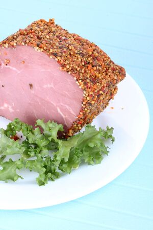Bloated beef on white plate, closeup on blue backgroundの写真素材
