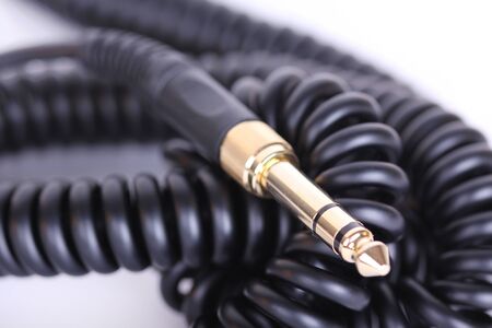 Spiral  headphones cable, closeup on whiteの写真素材
