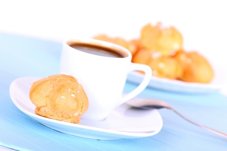 Cup of coffee and tasty cakes on blue mat, closeupの写真素材