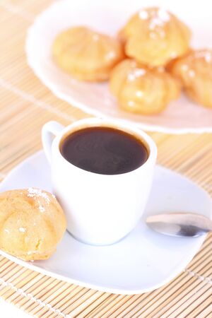 Cup of coffee and cakes, closeup on wooden matの写真素材