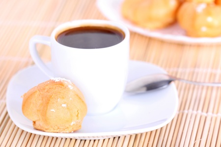 Cup of coffee and cakes on wooden mat, closeupの写真素材