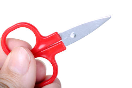 Scissors in hand, closeup on whiteの写真素材