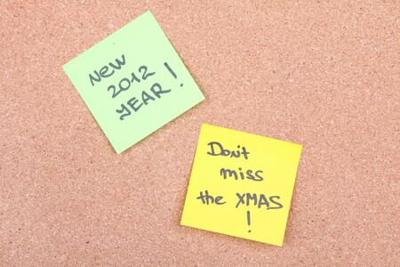 Paper notes with sign new year 2012 and don't miss on board, closeupの写真素材