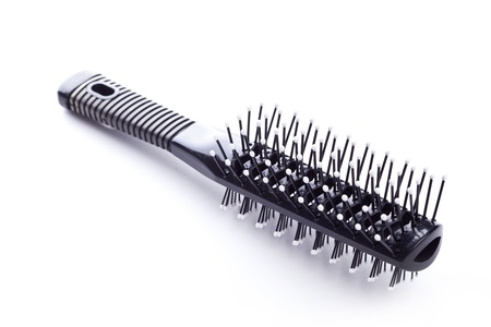 Black comb closeup on white backgroundの写真素材