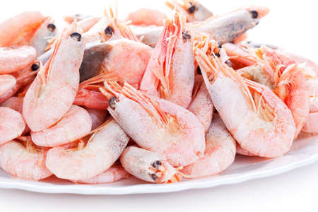 Pile of shrimps on plate, closeup on white backgroundの写真素材