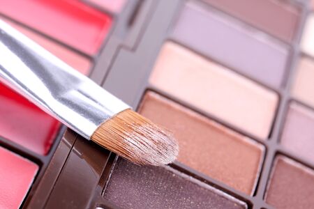 Make-up brush on eyeshadows palette, closeupの写真素材