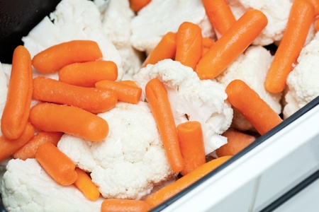 Cabbage and carrots in steam cooker, closeupの写真素材